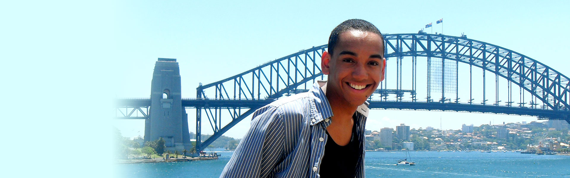 A student poses in from of Sydney Harbour bridge