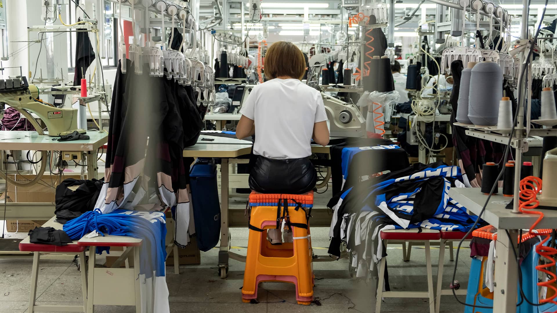 A woman working in a textile sweatshop